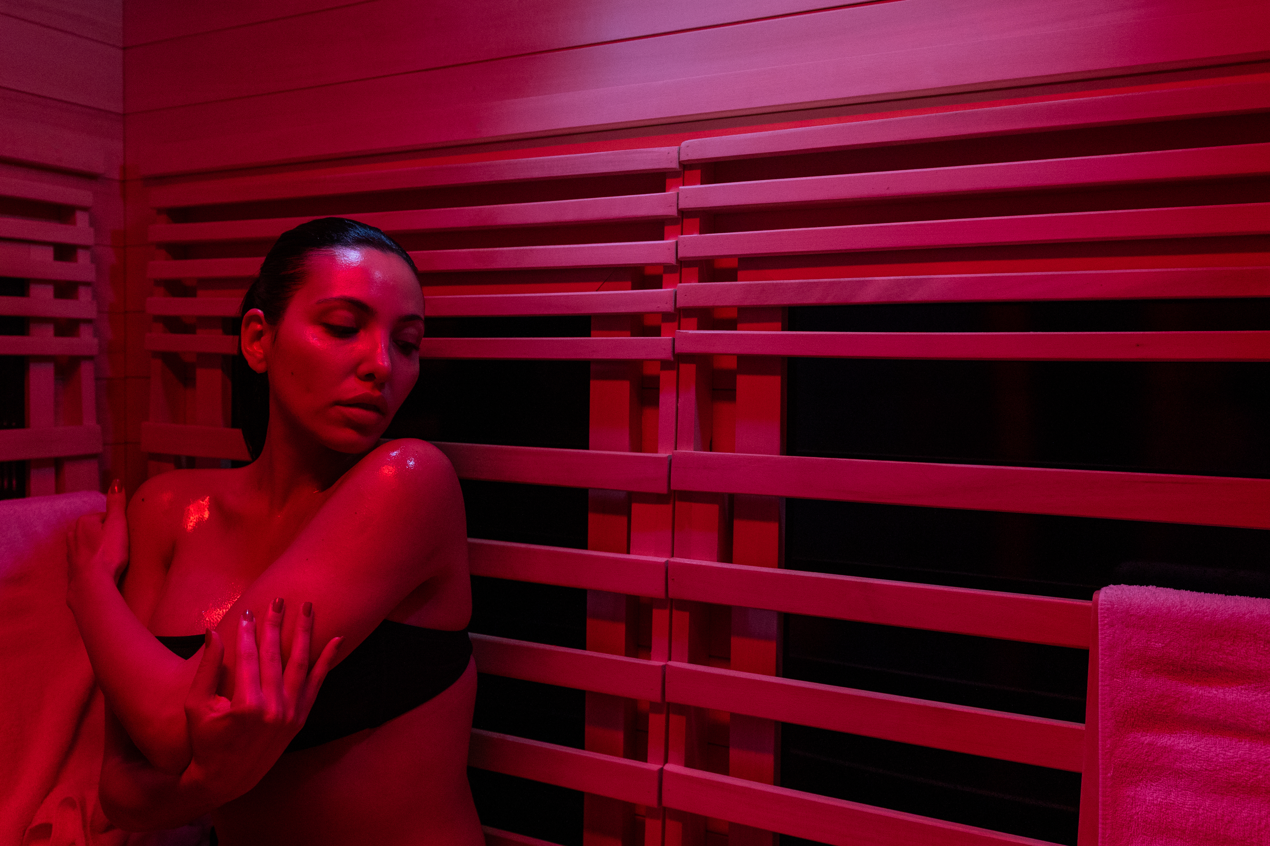 Guest relaxing in a beem infrared light sauna